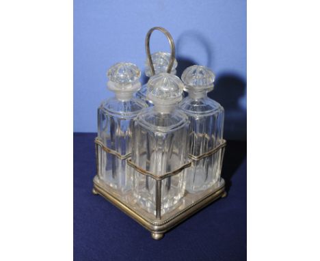 Silver plated four sectional decanter stand with four square cut glass decanters with fluted detail and cut glass stoppers