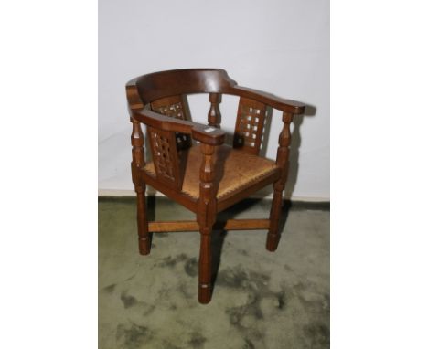 Robert Thompson 'Mouseman' 1960s oak armchair with upholstered seats and lattice work panels with X shaped stretcher 