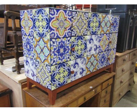 A decorative contemporary chest of three long drawers with simulated ceramic tiled finish raised on short tapered supports 11