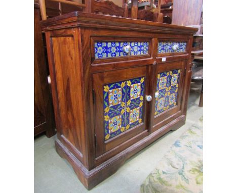 A low contemporary Indian hardwood side cupboard, enclosed by two doors and two drawers with decorative ceramic tiles, togeth