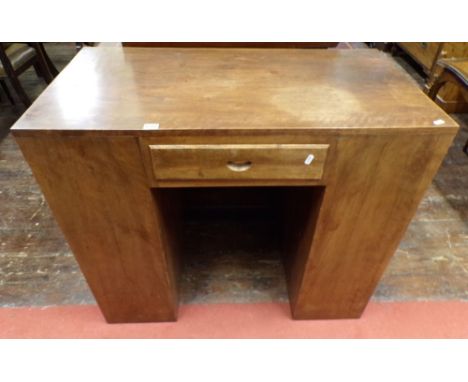 An art deco walnut kneehole desk, with central frieze drawer, each pedestal with side open doors, enclosing a series of shelv