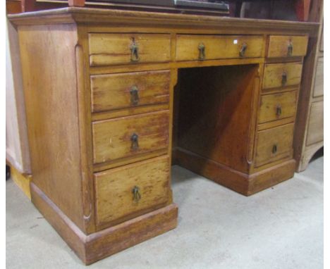 A Victorian gothic revival ash kneehole pedestal desk/dressing table fitted with an arrangement of nine drawers with brass dr