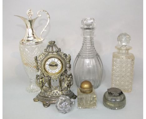 A glass inkwell with plated mount, a pierced brass mantle clock, a decanter and stopper, etc