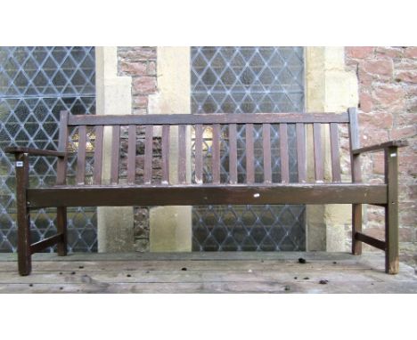 A stained teak garden/park bench with slatted seat and back, 190 cm long approx