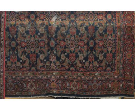 Persian country house carpet with various scrolled foliage upon a blue ground, 400 x 300cm (af)