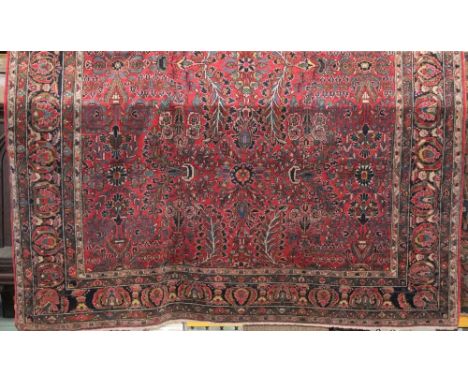 Good quality Persian tight weave carpet with various floral sprays upon a red ground, 380 x 285cm