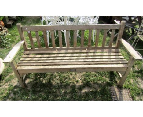 A weathered teak three seat garden bench with slatted seat and back with indistinct rectangular label for R A Lister, 160 cm 