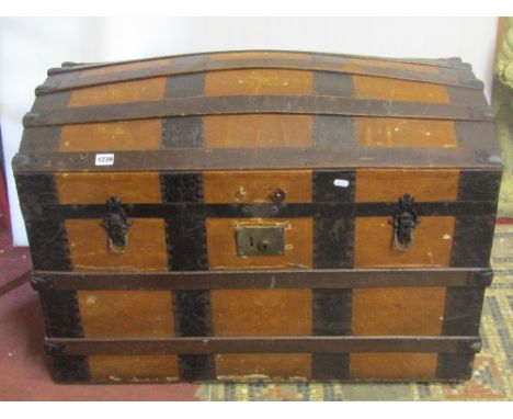 A late 19th century travelling trunk with domed lid, steel banded and timber lathe detail
