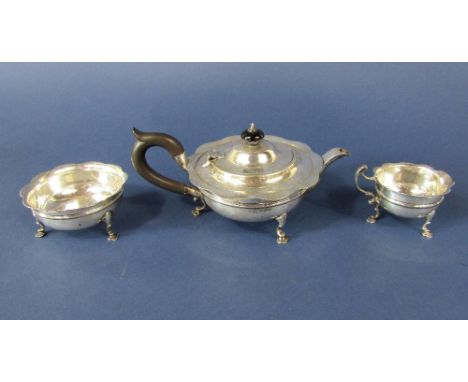 Three piece silver bachelor tea service, comprising tea pot, milk jug and sucrier, with wavy rims and cabriole hoof feet, mak