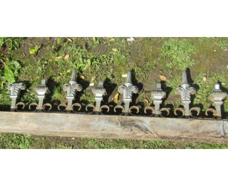 A run of reclaimed cast iron railing with alternating finials and mounted on a wooden block, 146 cm long