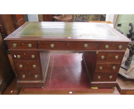 A Victorian mahogany pedestal writing desk of nine drawers with inset leather top, 135cm wide