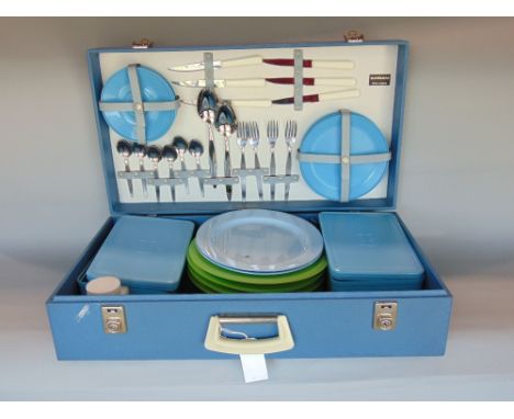 Sirram vintage picnic set, in a blue vinyl suitcase enclosing flatware plates, tupperware, etc