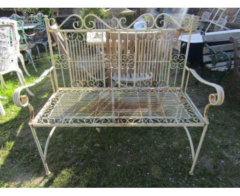 A contemporary cream painted light steel two seat garden bench with decorative scrollwork detail, slatted seat and folding fr