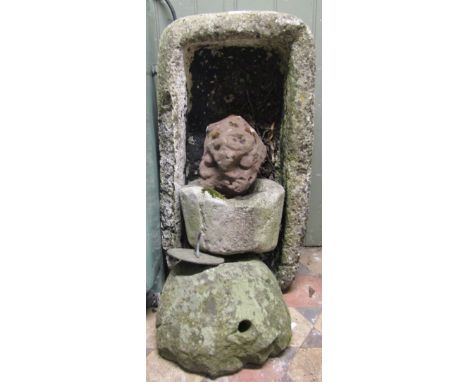 A weathered trough of rectangular form, a small stone planter, or possible mortar, a well weathered natural stone lions mask,