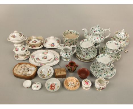 A collection of 19th century child's dinner wares with painted floral sprigs comprising two tureens and covers, further servi