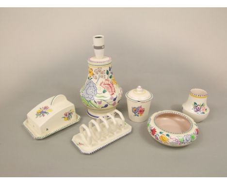A collection of Poole Pottery floral decorated wares including a lamp base, 20cm tall excluding fittings, toast rack, cheese 