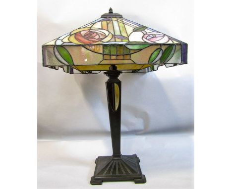 Tiffany &amp; Co style table lamp, the leaded glass shade with art nouveau foliage upon a tapered square column and faceted p