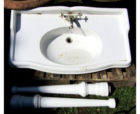 An old England white glazed hand basin raised on a pair of tapered leg supports (complete with mixer tap)