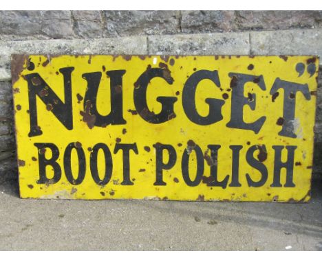 An old enamel sign of rectangular form advertising Nugget Boot Polish with black lettering on a yellow ground, 122 cm x 61 cm