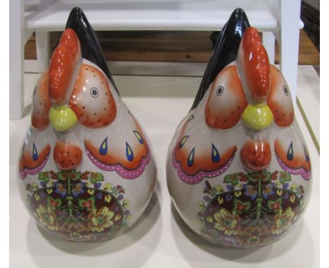 A pair of contemporary novelty ceramic cockerels with brightly painted finish
