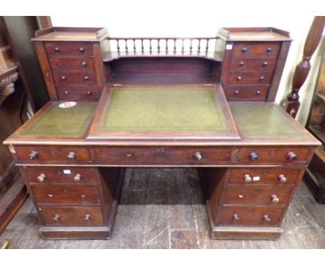 A Victorian mahogany Dickens desk of usual form, fitted with nine frieze drawers, leather top, writing slope and a further ar