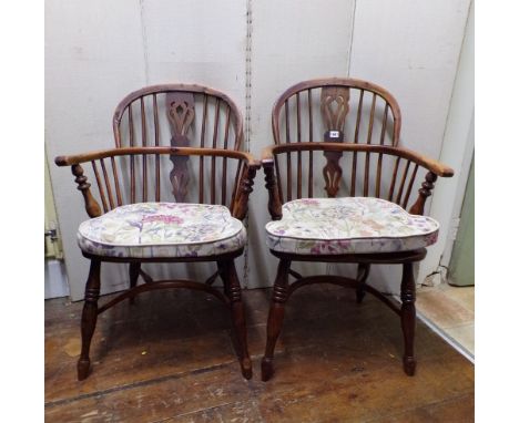 A pair of Georgian Windsor comb back elbow chairs in elm and yew wood on crinoline stretchers