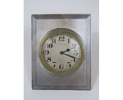 Silver easel timepiece, the sunburst dial with Arabic numerals, engine turned frame, 9.5cm high