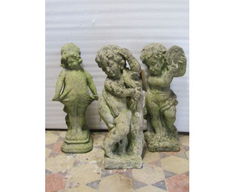 A weathered cast composition stone garden ornament in the form of a standing cherub playing a tambourine, together with one o