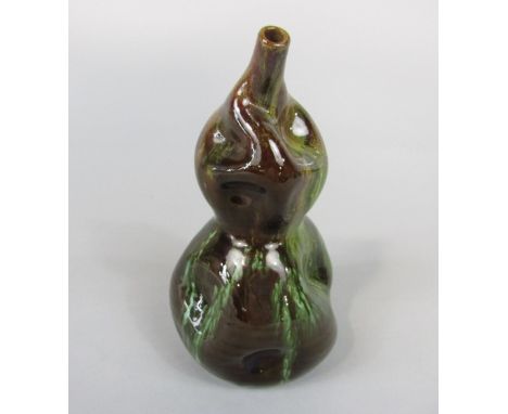 A Linthorpe Pottery vase designed by Dr Christopher Dresser, of asymmetrical form with streaked green glaze, impressed mark a