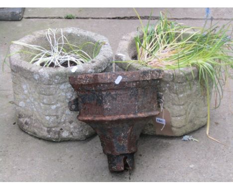 A pair of weathered contemporary cast composition stone planters of octagonal form with relief detail (planted), together wit