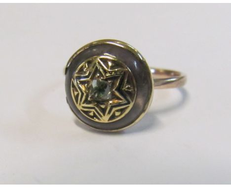 A Georgian mourning ring with diamond, rock crystal and black enamel