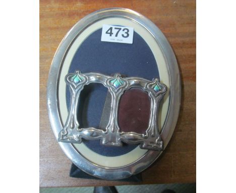 An oval silver photo frame and a silver and enamel small double photo frame