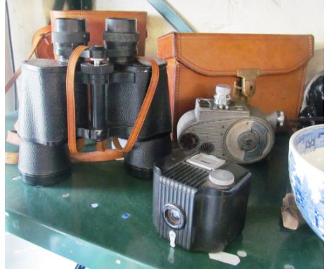 A pair of Omega 7 x 50 binoculars No 82362 (i.c), a Bell and Howell Sportster and some camera accessories (i.c)