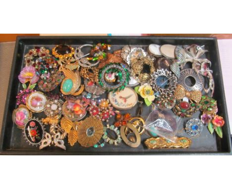 A black tray with brooches
