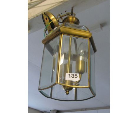 A brass lantern ceiling light and opaque glass ceiling light