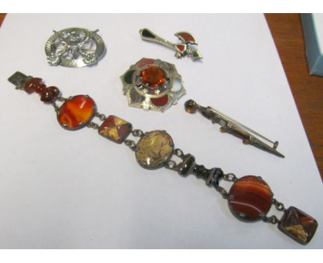 A Scottish agate bracelet, circular brooch, axe brooch, Dirk brooch (one stone missing) and a stag brooch (stone missing)