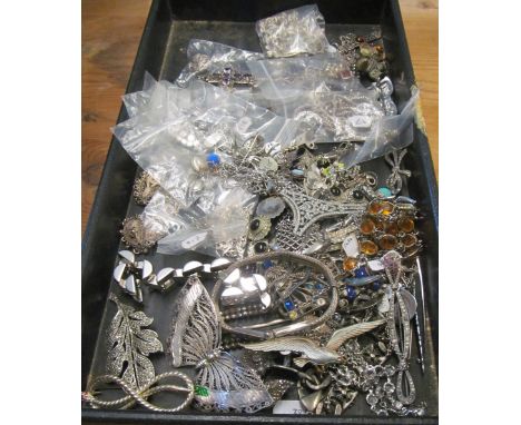 A black tray of diamante and silver coloured jewellery