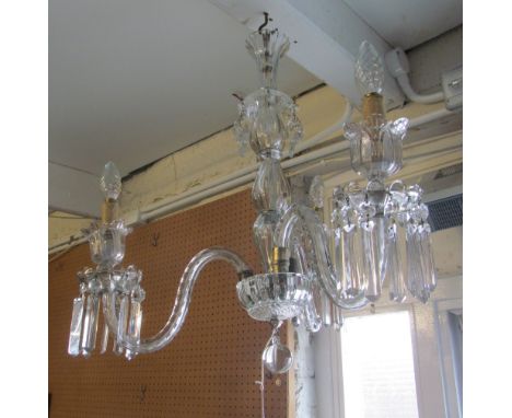 A three branch chandelier with crystal drops