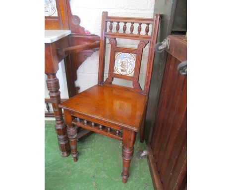 A pair of oak hall chairs with tile backs