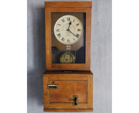 An antique oak wall hanging clocking-in clock by Gledhill-Brook-Time-Recorder Ltd. H.99 W.40 D.30cm 