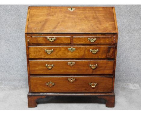 A Georgian mahogany bureau with fitted interior above two short over three long graduating drawers on bracket feet. H.108 W.9