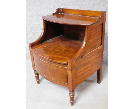 A Georgian mahogany night table with folding shelf and  panel enclosing compartment on turned tapering supports. H.70 L.60 W.