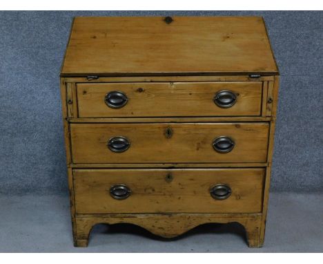 A Georgian pine bureau the fall front revealing fitted interior above three graduating drawers on bracket feet. H.100 W.86 D.