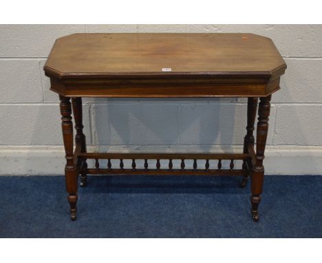 AN EDWARDIAN WALNUT RECTANGULAR CARD TABLE, the top with canted corners, fold over top enclosing a green playing surface, on 