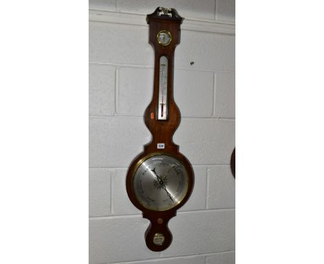 AN EARLY 19TH CENTURY ROSEWOOD CASED WHEEL BAROMETER, broken swan neck pediment with brass urn to centre, fitted with dry/dam