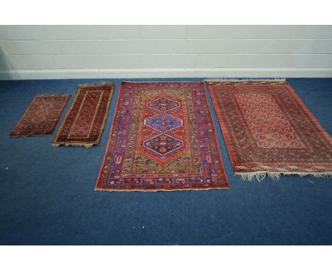 A TEKKE RED GROUND RUG, with multi strap border, 199cm x 127cm together with a bokara ground rug 213cm x 125cm, a small red c