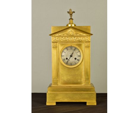 A MID 19TH CENTURY ORMOLU MANTEL CLOCK OF ARCHITECTURAL FORM, the rectangular top with dove finial above a classical portico 