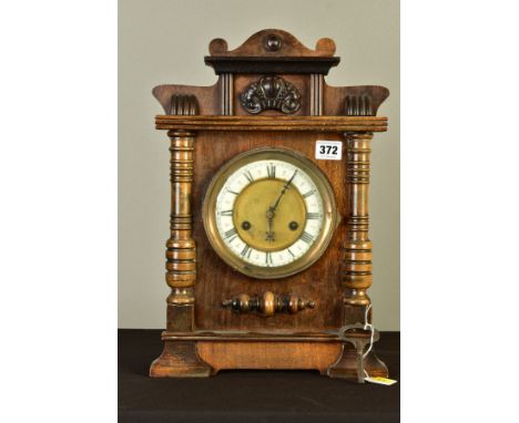 A LATE 19TH CENTURY WALNUT CASED MANTEL CLOCK, rectangular outline with moulded pediment, enamel chapter ring with Roman nume