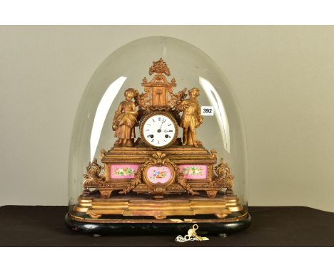 A MID/LATE 19TH CENTURY GILT METAL AND PORCELAIN FRENCH MANTEL CLOCK, cast as a couple standing either side of a water founta