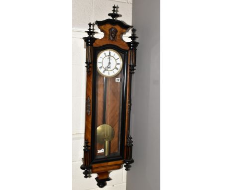 A LATE 19TH CENTURY WALNUT AND EBONISED CASED VIENNA REGULATOR WALL CLOCK, the wavy pediment with three turned finials and a 